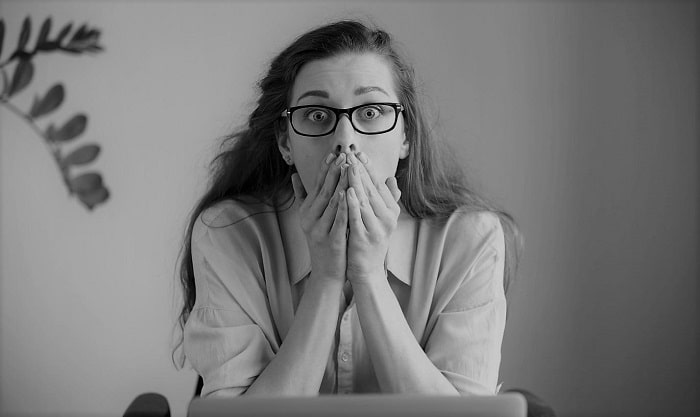 woman at the office covering mouth