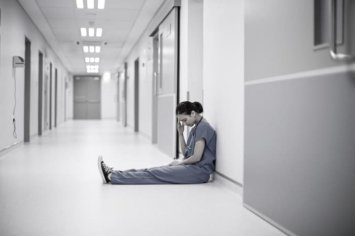 sad female doctor on hospital corridor