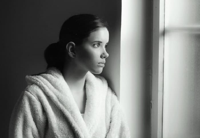 young sad girl in bath robe