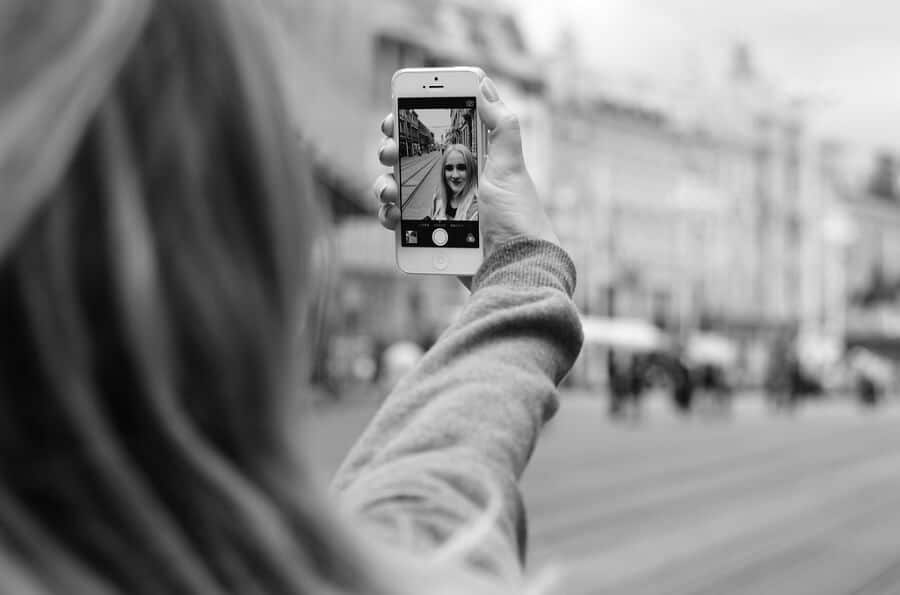 view from behind of a woman taking a selfie