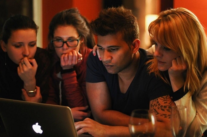 friends in front of laptop