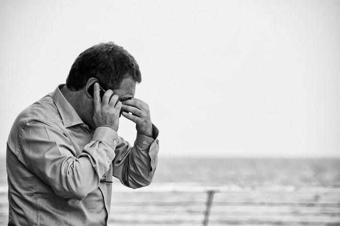 man talking on the phone stressed
