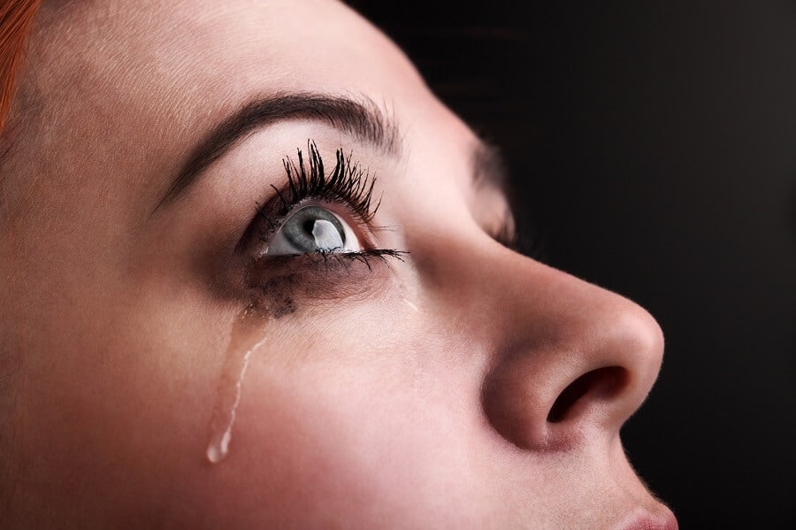 woman crying and looking up