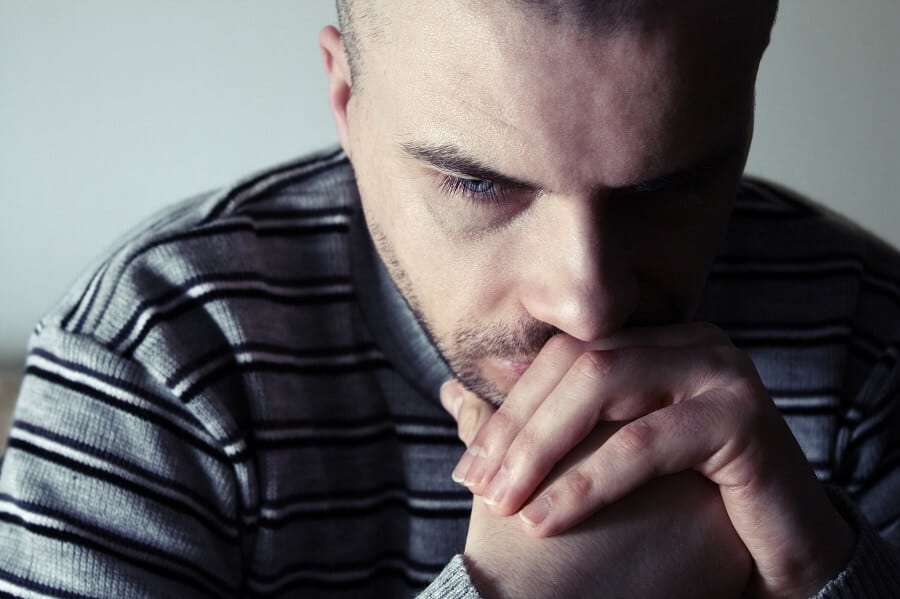 man looking down and seeming depressed