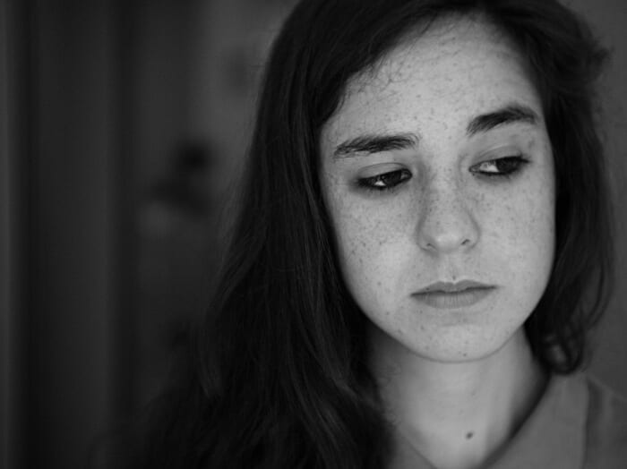 black and white photo of a sad woman