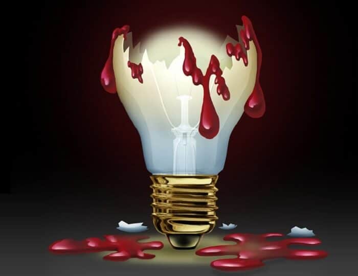 Broken light bulb with blood around it