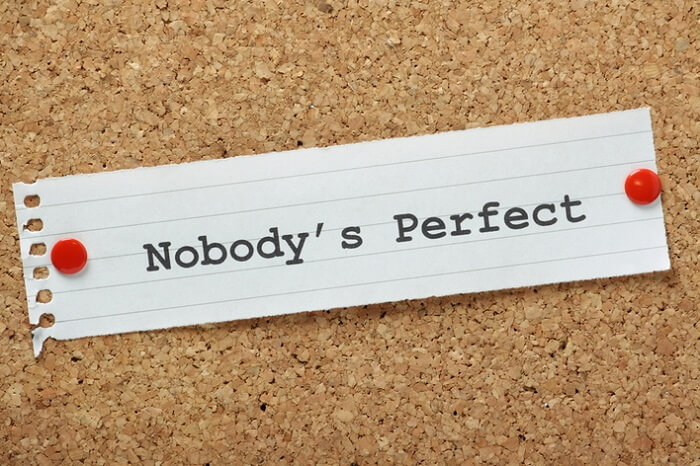 Message 'nobody is perfect' written on a white paper