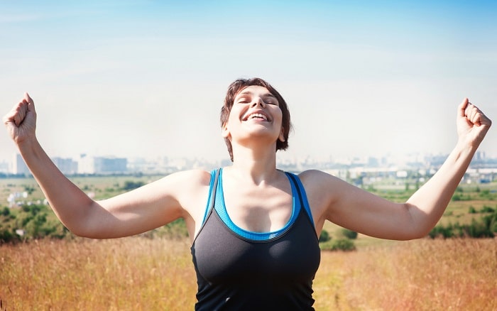 woman laughing in exercising attire