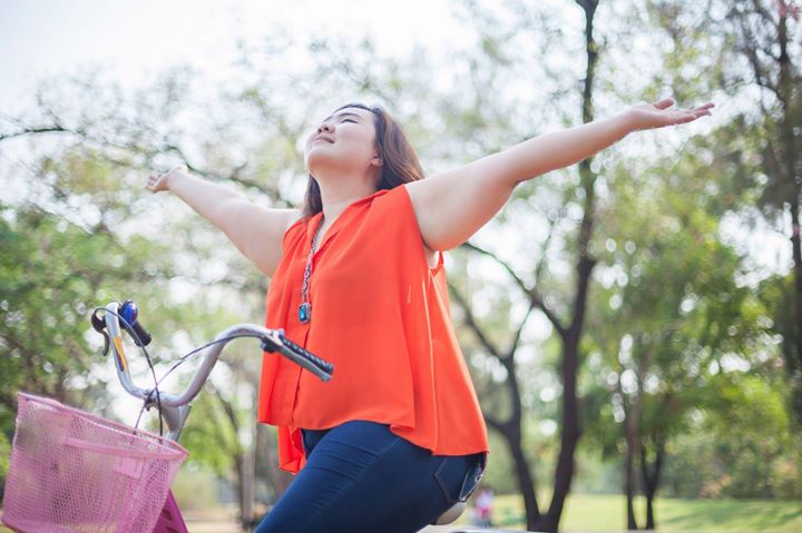 young woman riding a bicycle